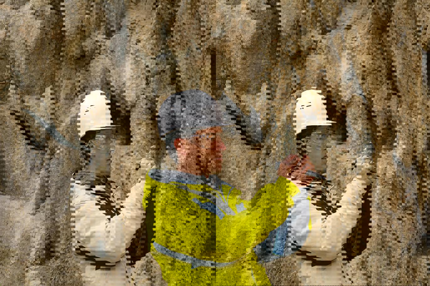 Man looking at a rock sample Man looking at a rock sample